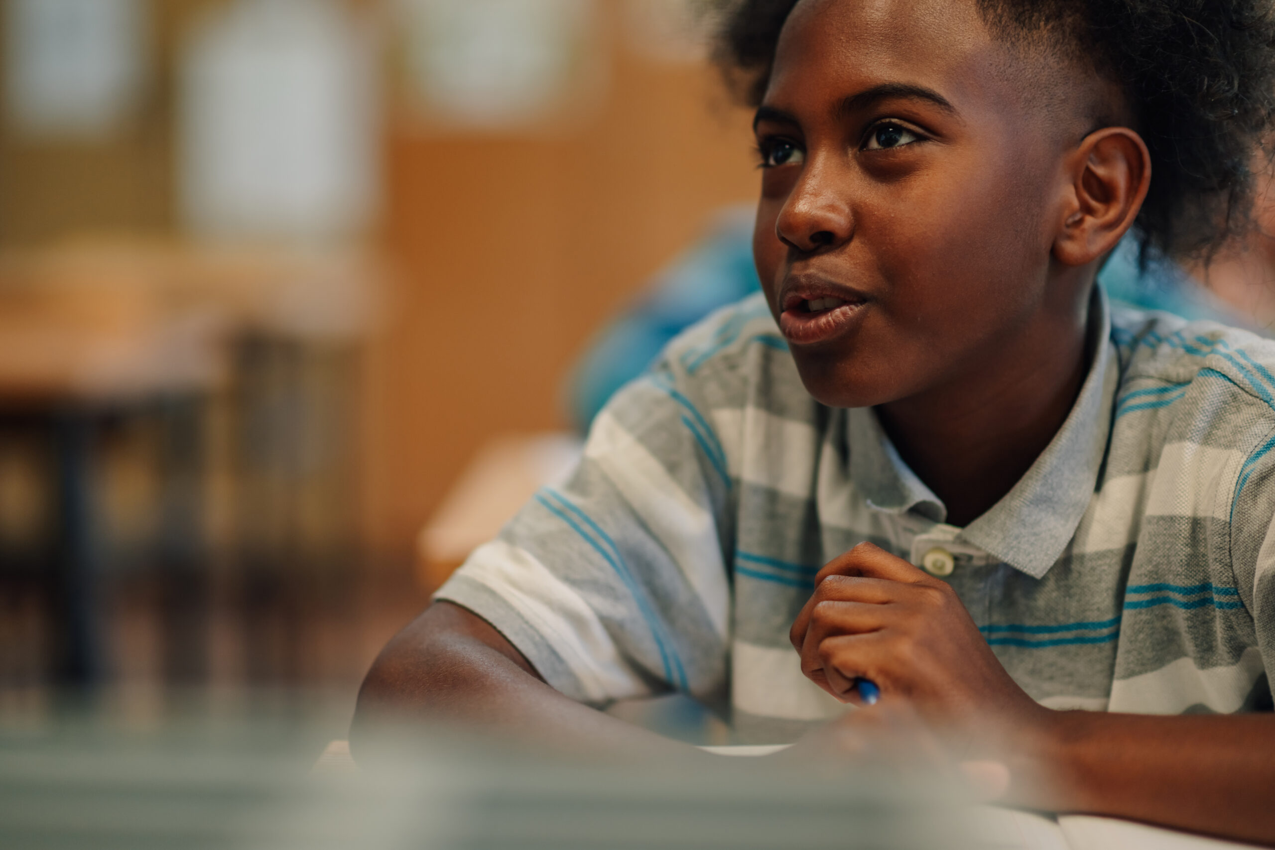elementary school student answering question in classroom