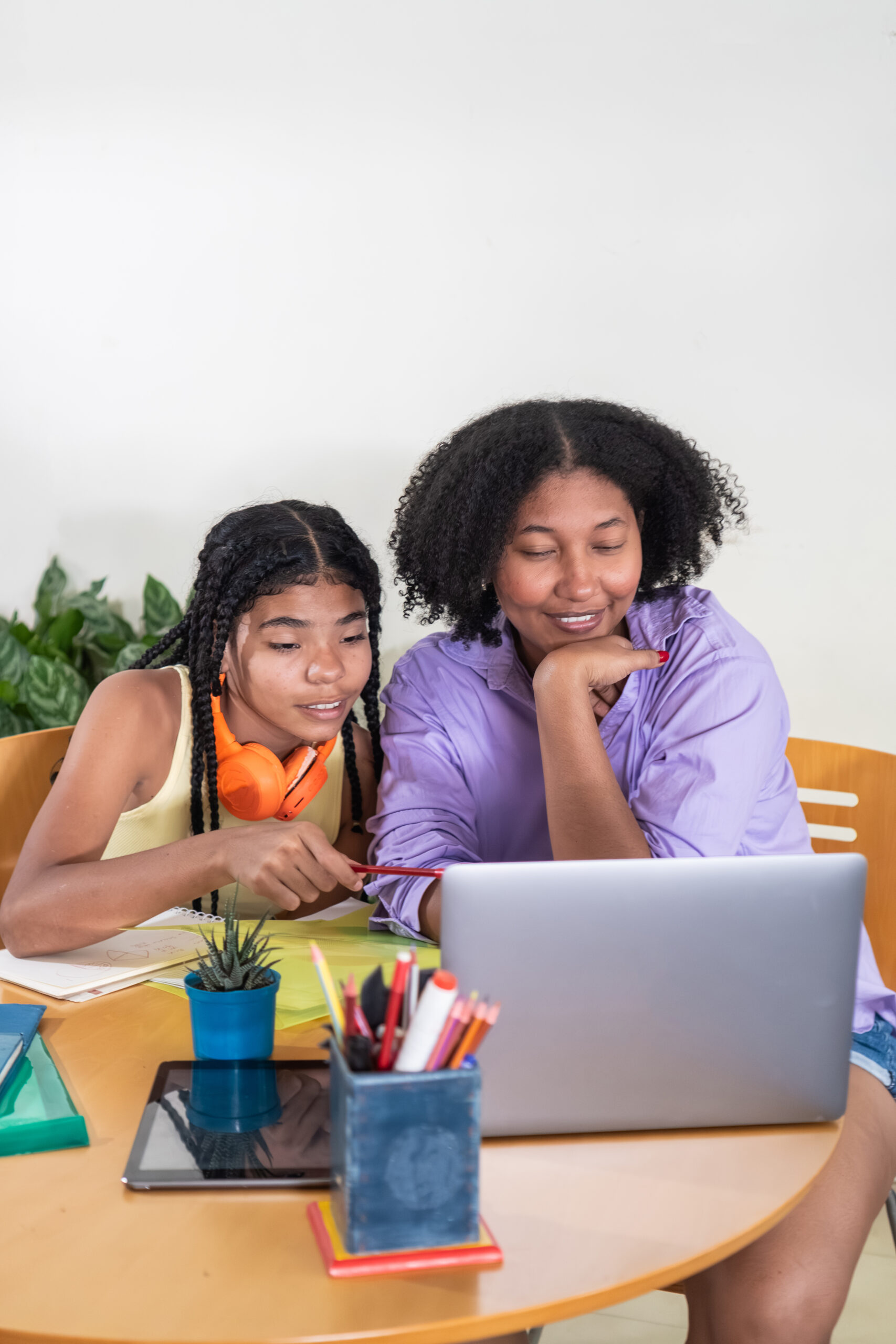 mother and daughter learning online with laptop at home