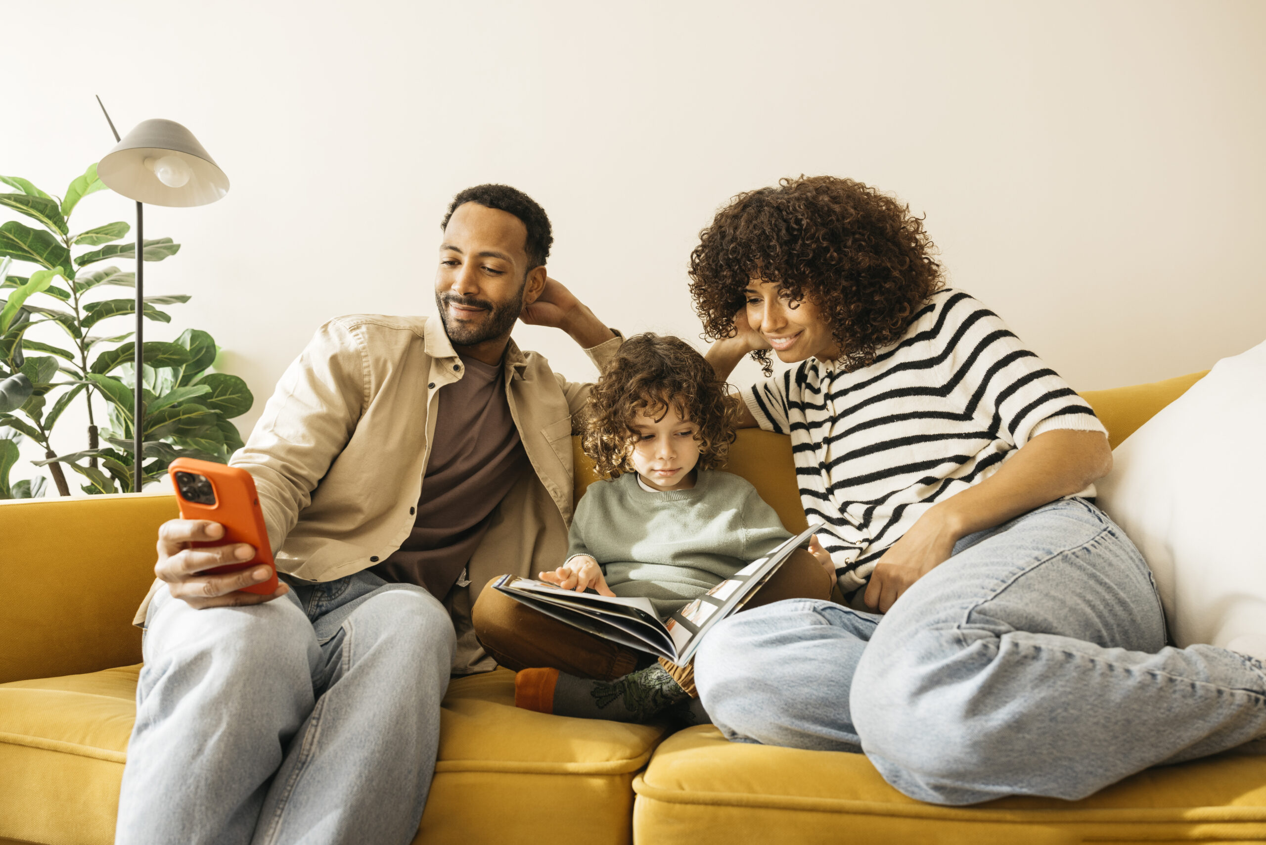 happy family enjoying quality time together on a cozy yellow sofa