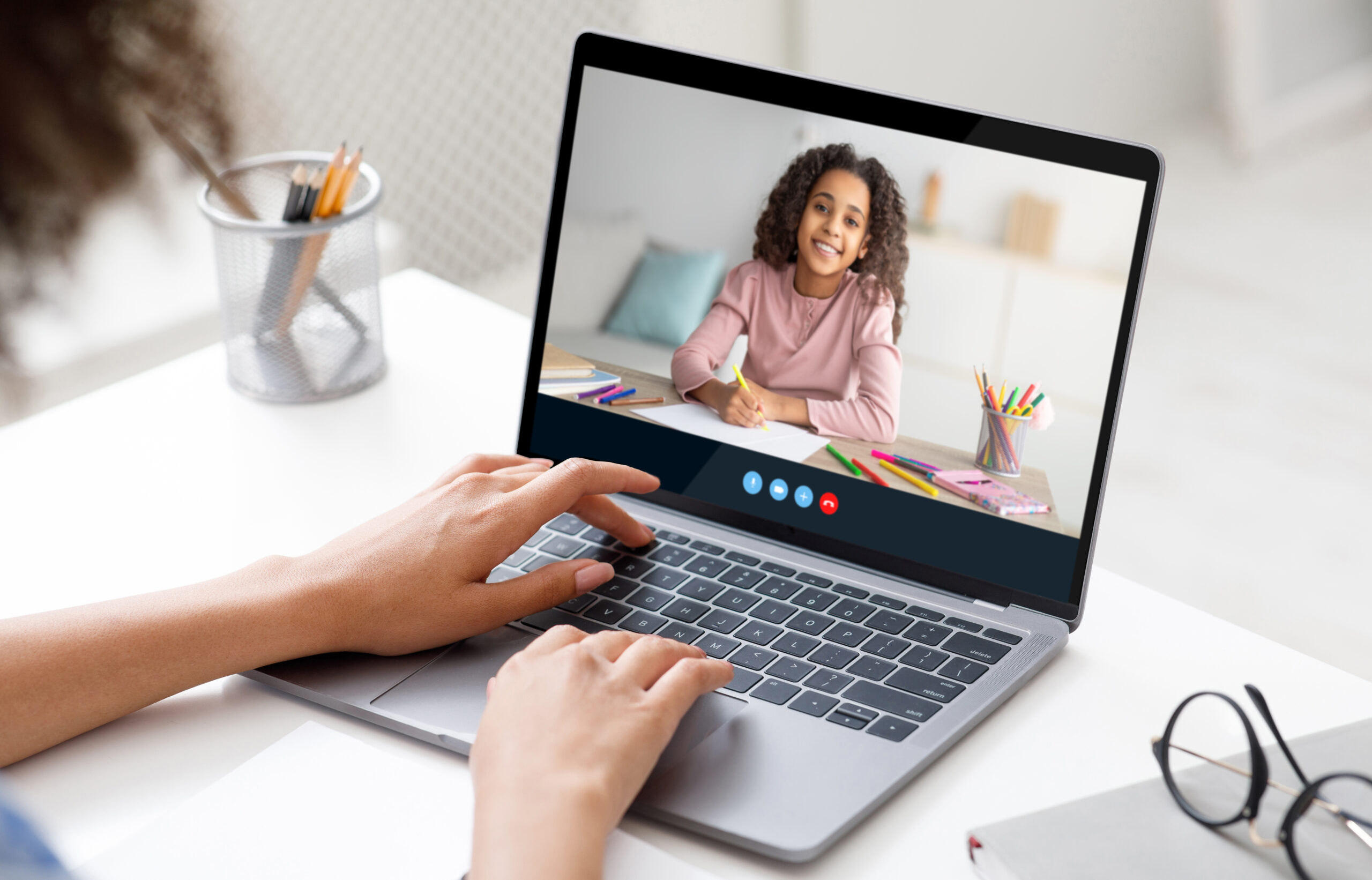 cropped black woman teacher calls online to teen girl on laptop screen for remote lesson, indoor