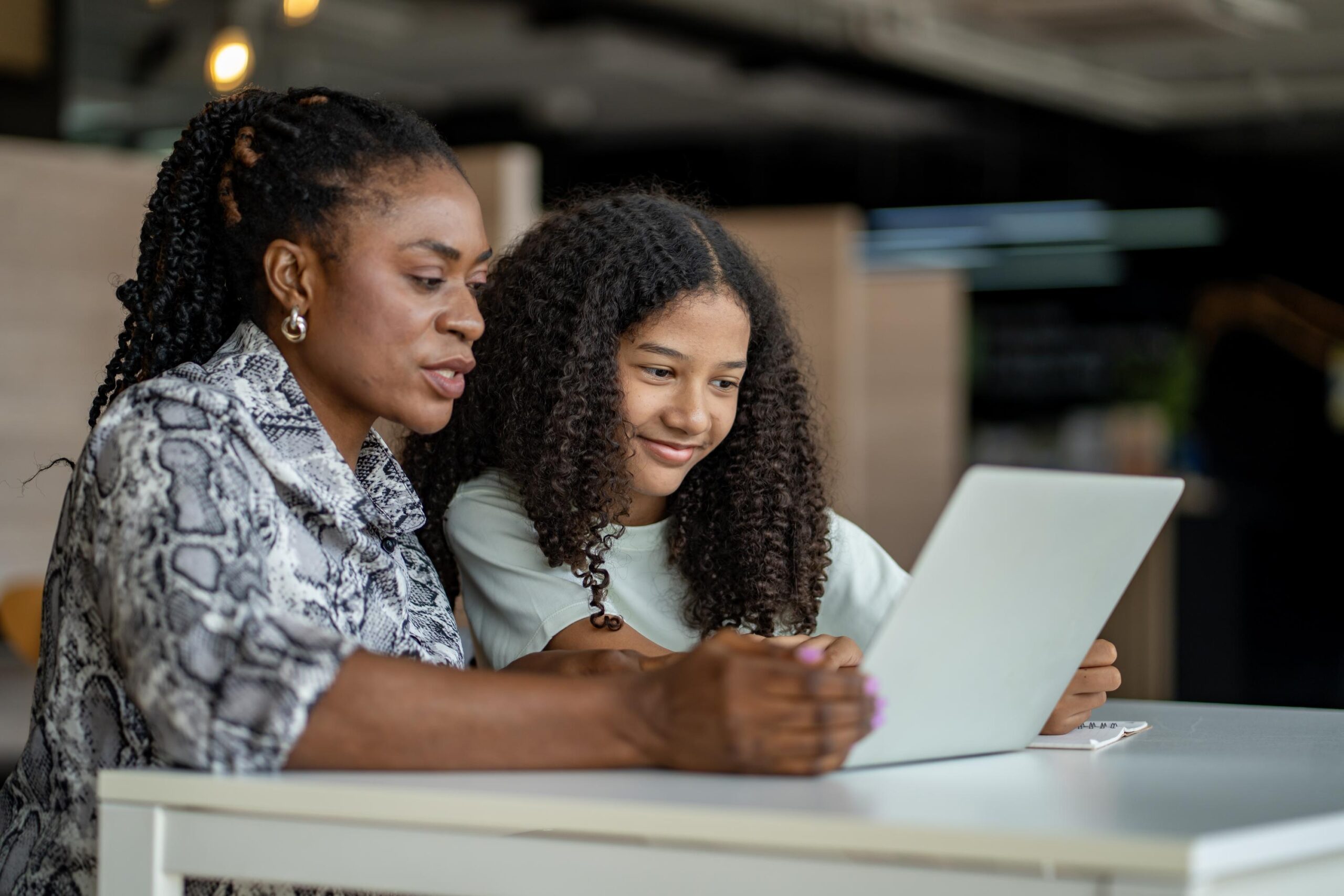 The Smart Family’s Guide to Choosing a Flexible, Accredited K-12 Virtual School This Year african school teacher is teaching and guiding young student in the class using information from experience and internet for academic literacy study and education